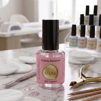 Flacon de Cuticle Remover ATLAS 15ml, présenté sur une table de travail en marbre avec des outils professionnels d'onglerie.