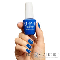 Presentation du flacon OPI Sea-ze the Day, avec une manucure sur ongles en amande avec le vernis semi-permanent bleu cobalt, fini brillant et opaque sans HEMA.